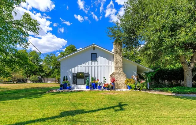 a front view of house with yard and green space