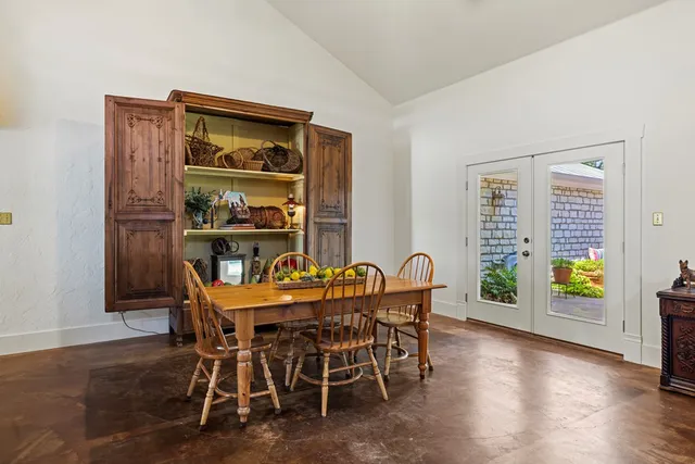 a view of a dining room with furniture and a window