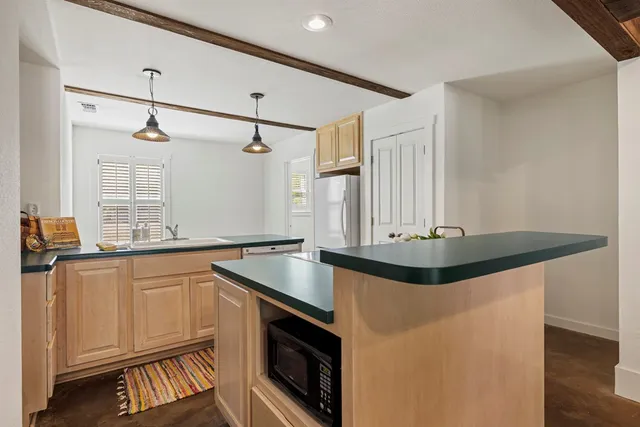 a kitchen with stainless steel appliances granite countertop a sink and a stove