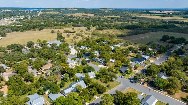 an aerial view of residential houses with outdoor space and river