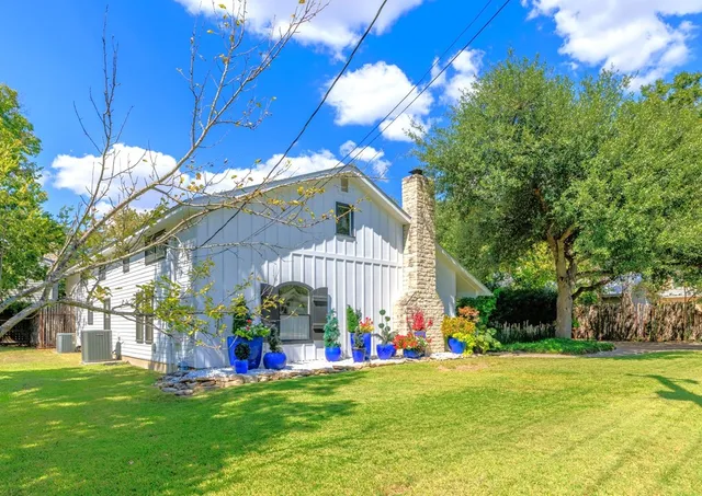 a front view of house with yard and outdoor seating