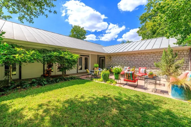 a view of a patio with table and chairs and potted plants