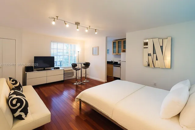 a bedroom with a bed and flat screen tv