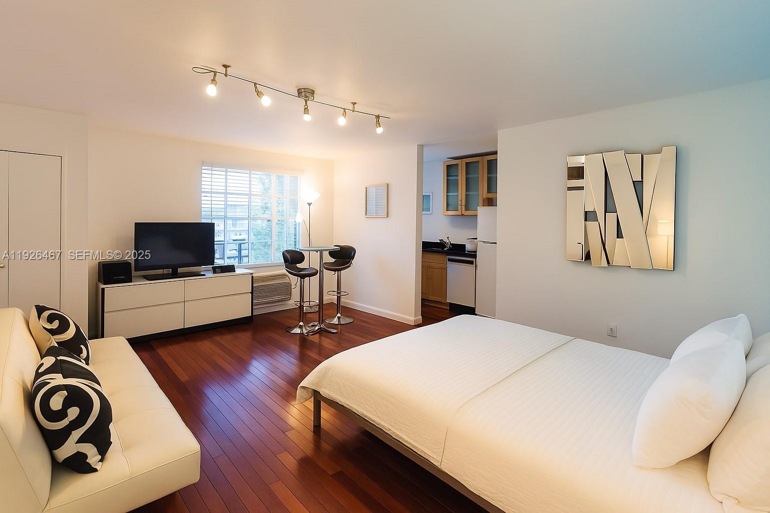 a bedroom with a bed and flat screen tv