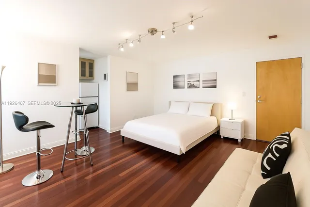 a bedroom with a bed and glass wall