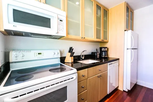 a kitchen with stainless steel appliances white cabinets and a sink