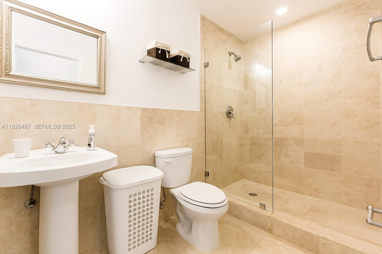 420 15th Street, Unit 106 Miami Beach, FL 33139 - Photo 6 of 9 a bathroom with a sink toilet and shower