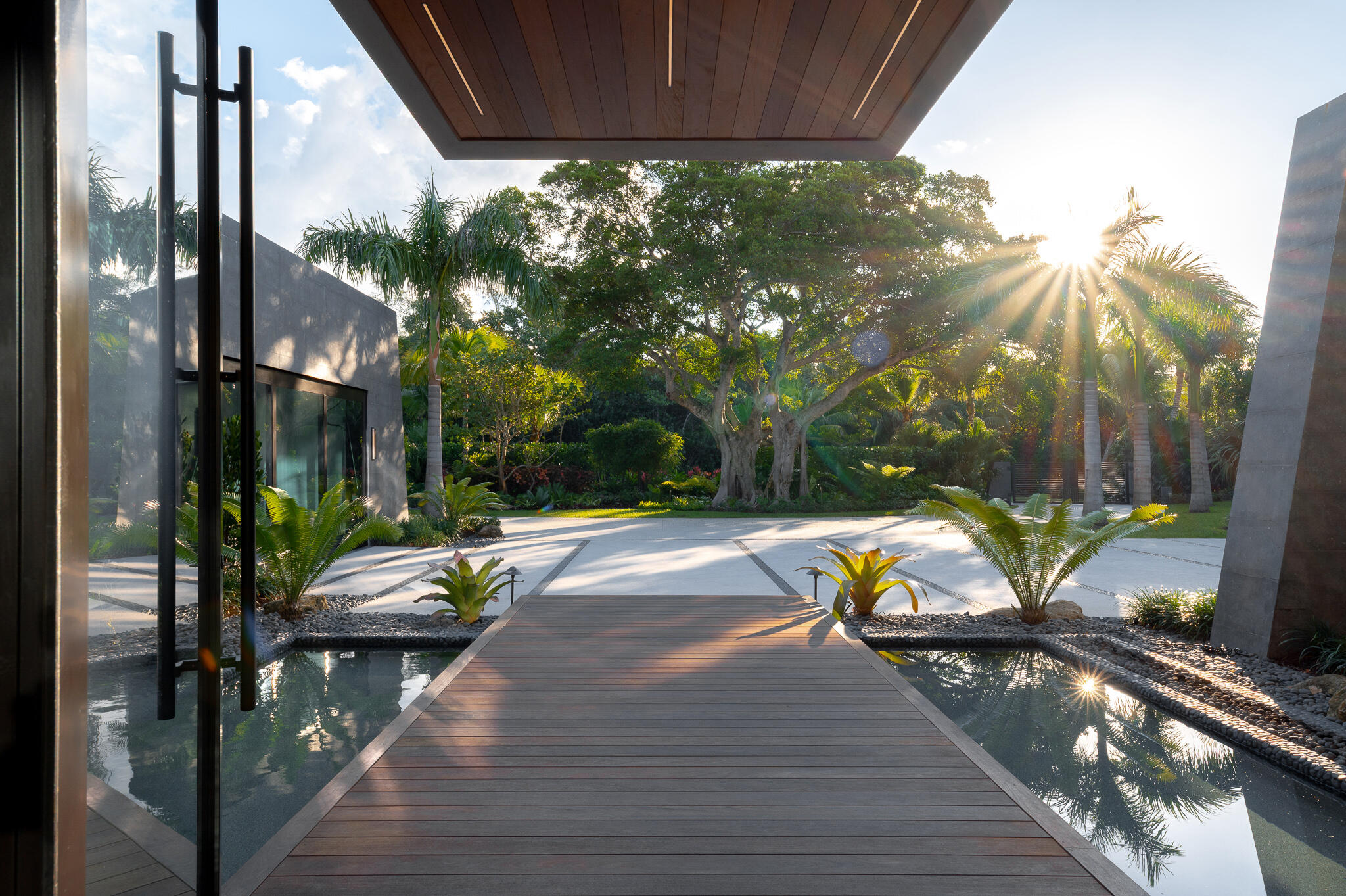 488 South Beach Road Jupiter Island, FL 33455 - Photo 8 of 54 a view of swimming pool with lounge chair and dinning table under an umbrella