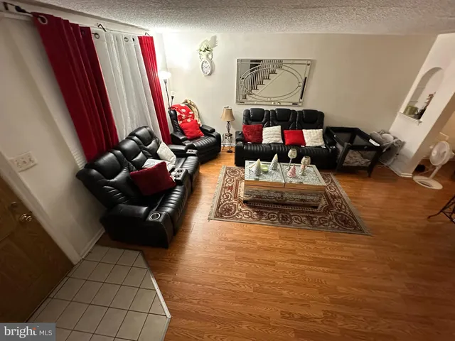 a living room with furniture gym equipment and a fireplace