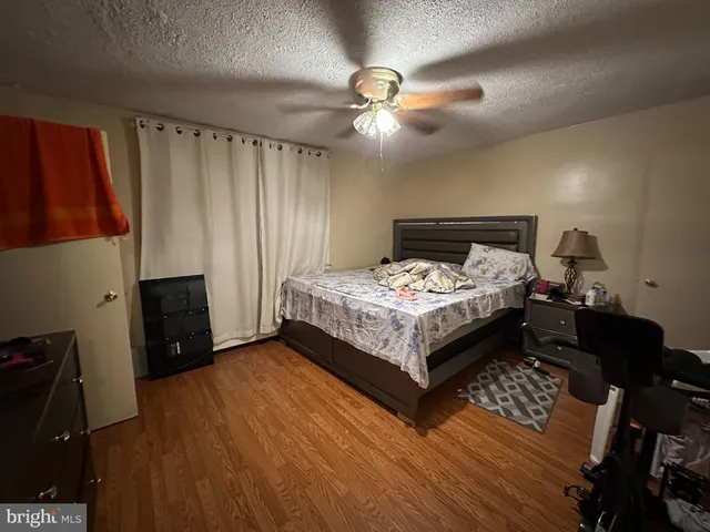 a bed room with a bed and a ceiling fan