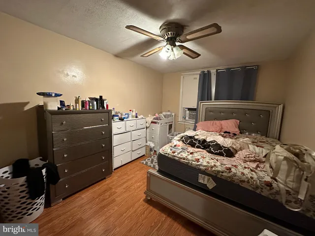 a bedroom with a bed and a ceiling fan
