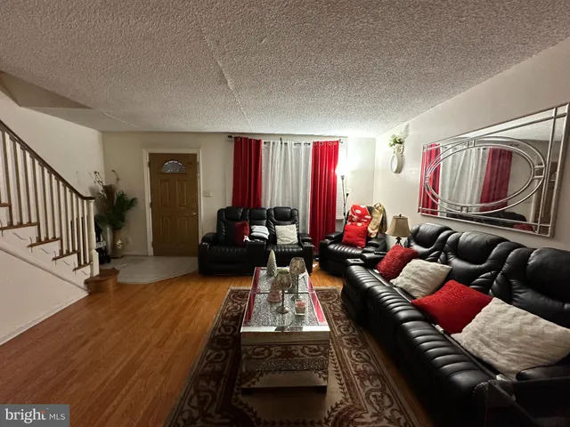 a living room with furniture and a red lamp