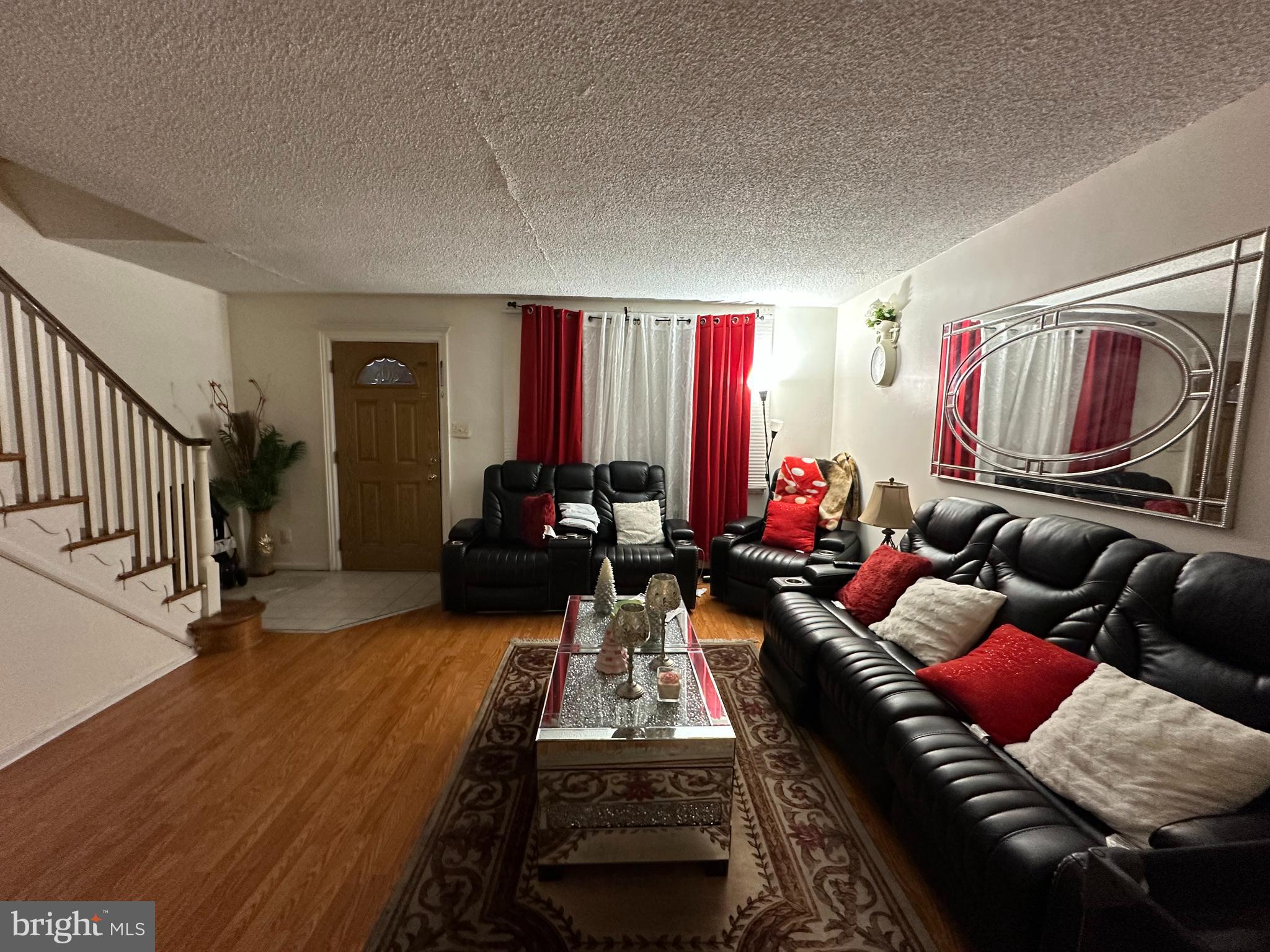 7143 Jackson Street Philadelphia, PA 19135 - Photo 5 of 23 a living room with furniture and a red lamp