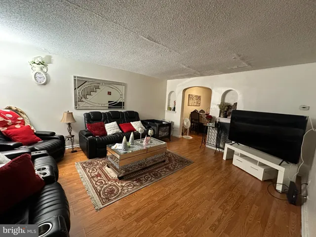 a living room with furniture gym equipment and a flat screen tv