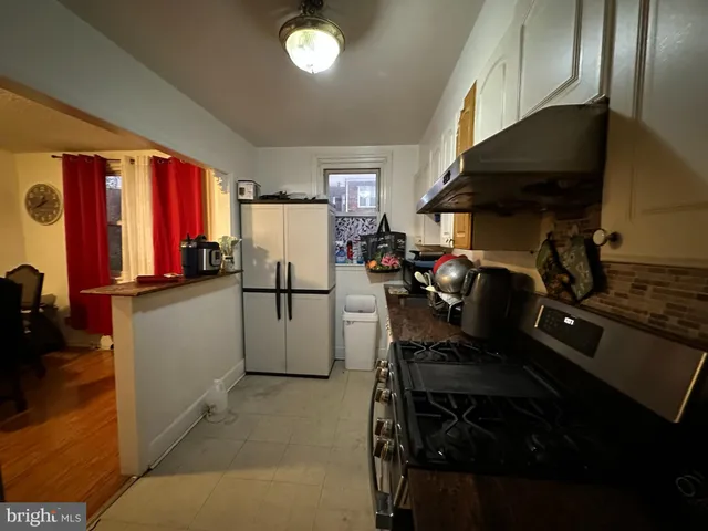 a kitchen with a sink appliances and cabinets