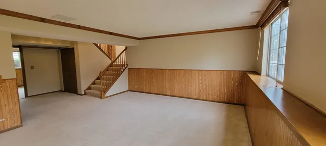 a view of a house with a yard and lawn chairs
