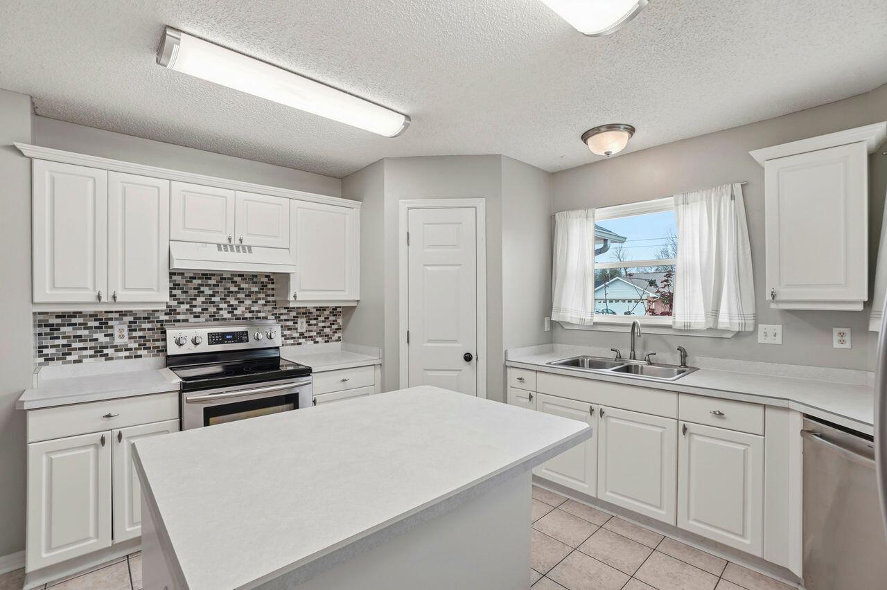 1285 Jefferyscot Drive Crestview, FL 32536 - Photo 11 of 41 a kitchen with a sink a stove and cabinets