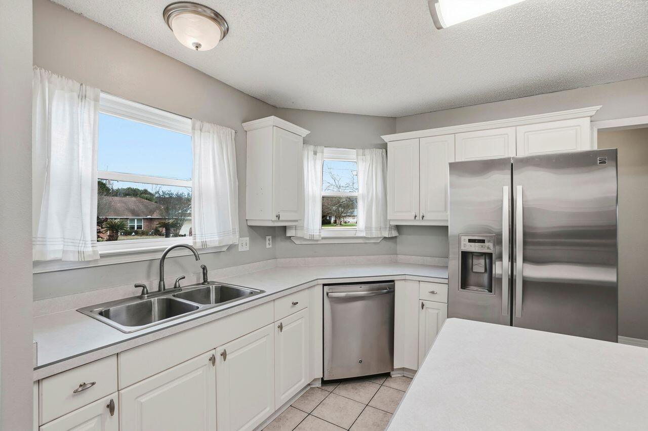 1285 Jefferyscot Drive Crestview, FL 32536 - Photo 12 of 41 a kitchen with a sink cabinets and window