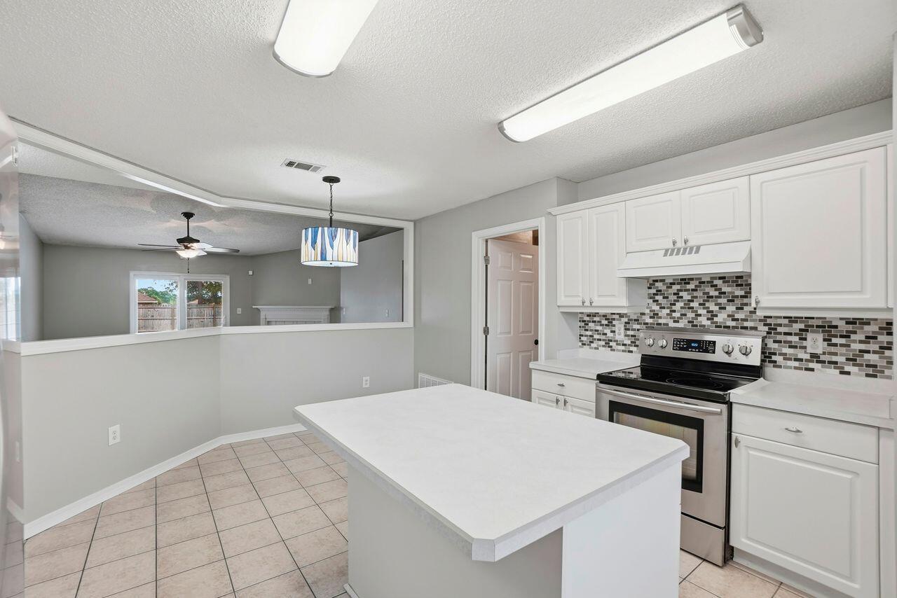1285 Jefferyscot Drive Crestview, FL 32536 - Photo 13 of 41 a kitchen with a sink a stove and cabinets