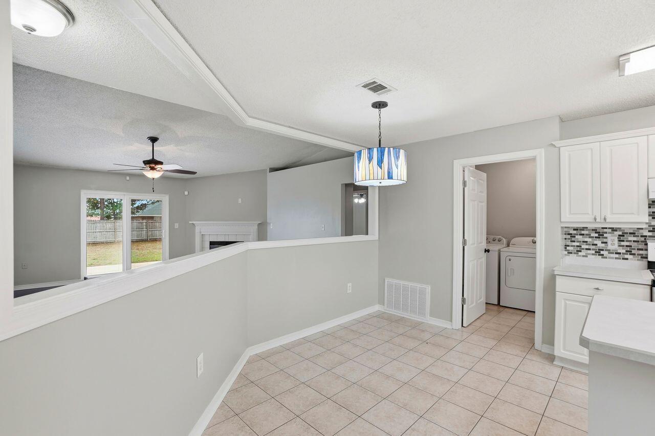 1285 Jefferyscot Drive Crestview, FL 32536 - Photo 15 of 41 a view of an empty room with a kitchen