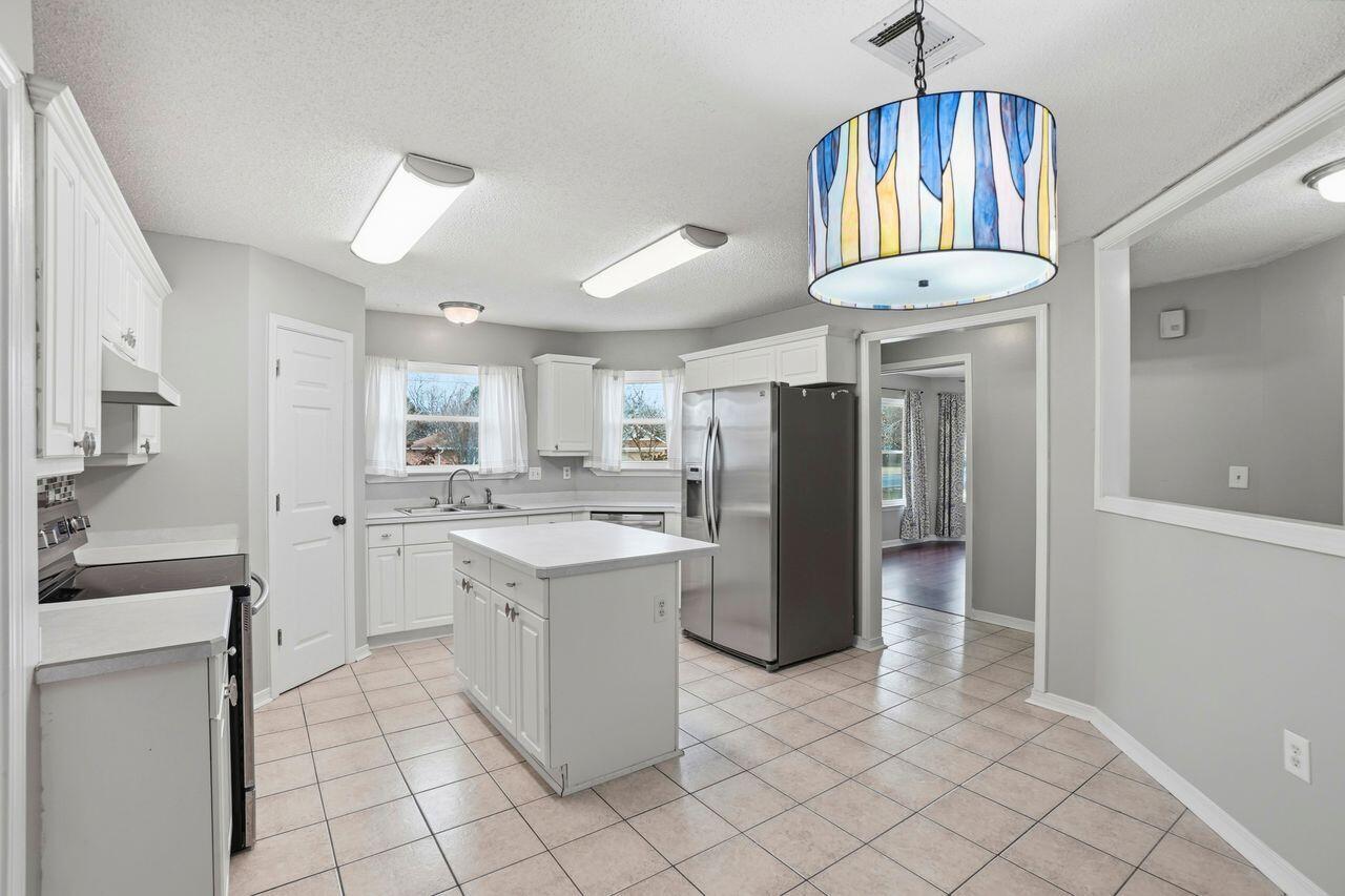 1285 Jefferyscot Drive Crestview, FL 32536 - Photo 16 of 41 a kitchen with refrigerator and cabinets