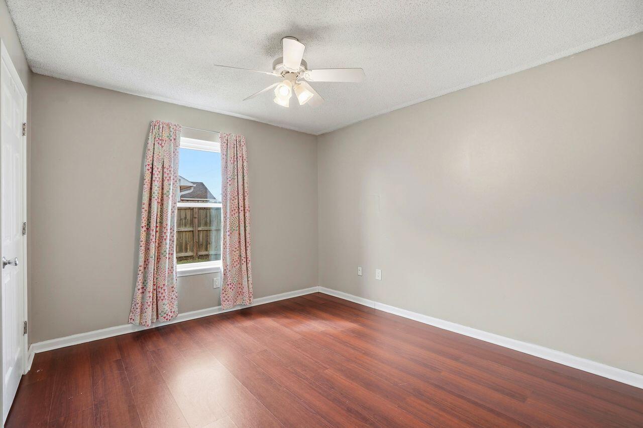 1285 Jefferyscot Drive Crestview, FL 32536 - Photo 20 of 41 wooden floor in an empty room with a window