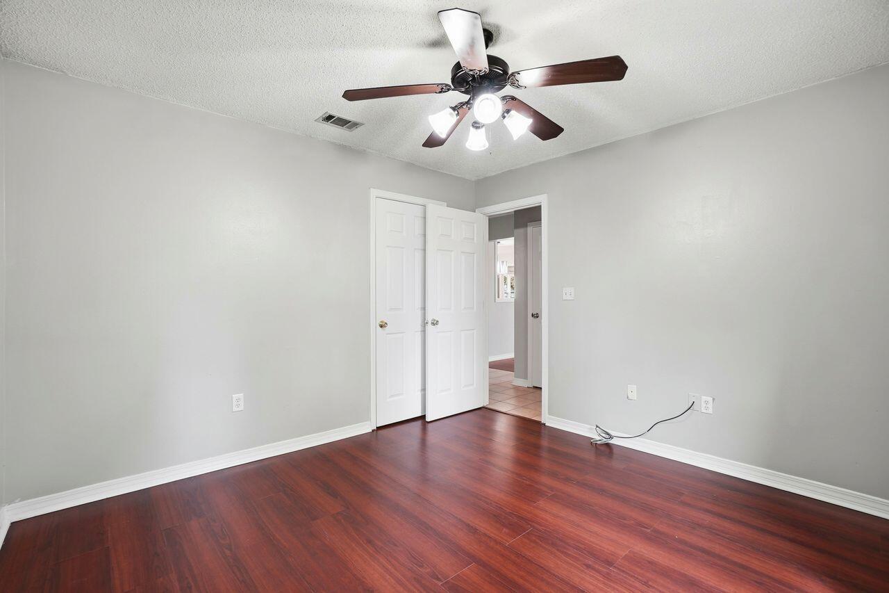 1285 Jefferyscot Drive Crestview, FL 32536 - Photo 23 of 41 a view of an empty room with wooden floor