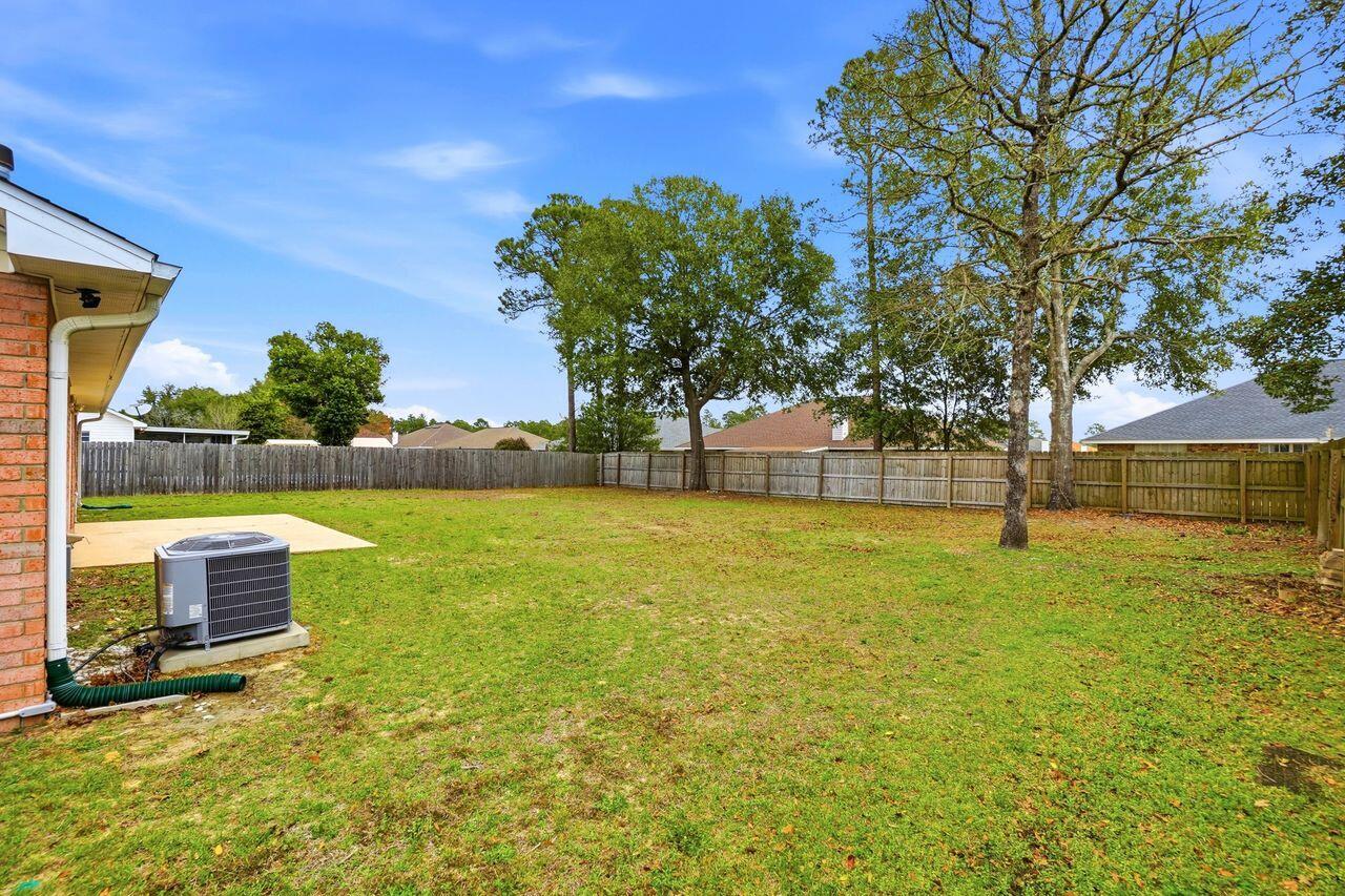 1285 Jefferyscot Drive Crestview, FL 32536 - Photo 38 of 41 a backyard of a house with lots of green space