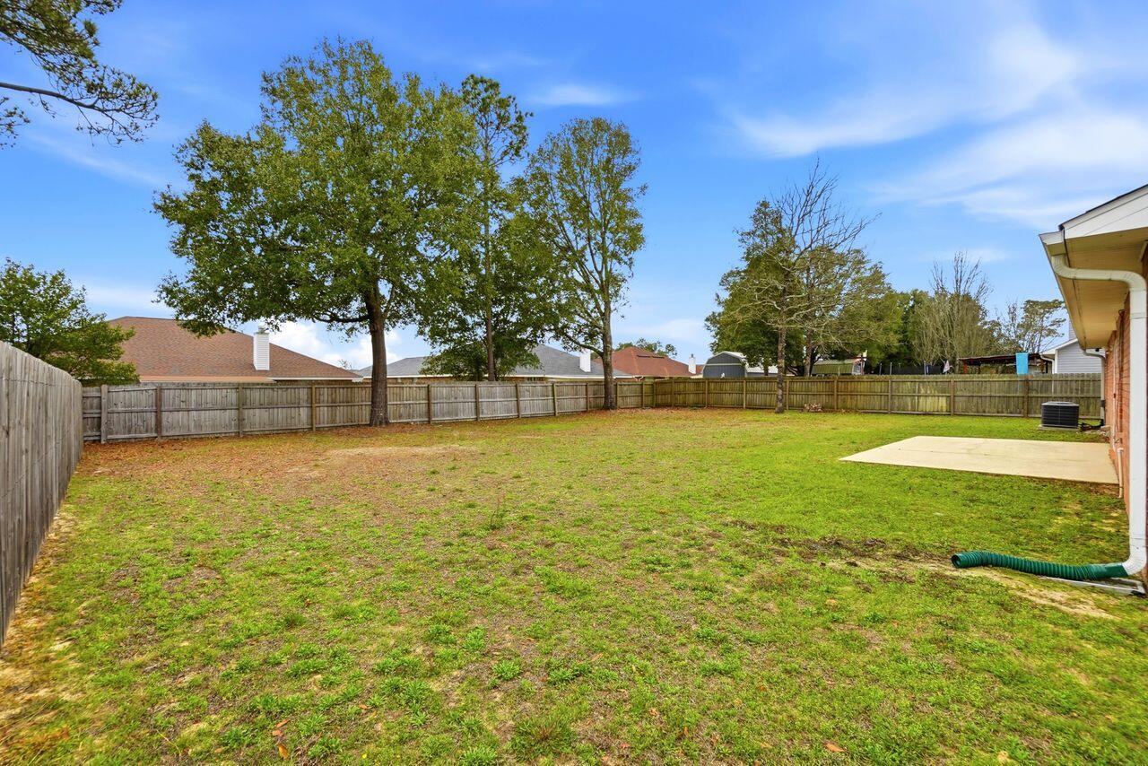 1285 Jefferyscot Drive Crestview, FL 32536 - Photo 41 of 41 a view of a yard with a house in the background