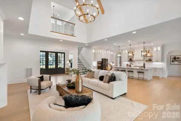 a kitchen with stainless steel appliances kitchen island granite countertop a sink a stove a refrigerator cabinets and chairs