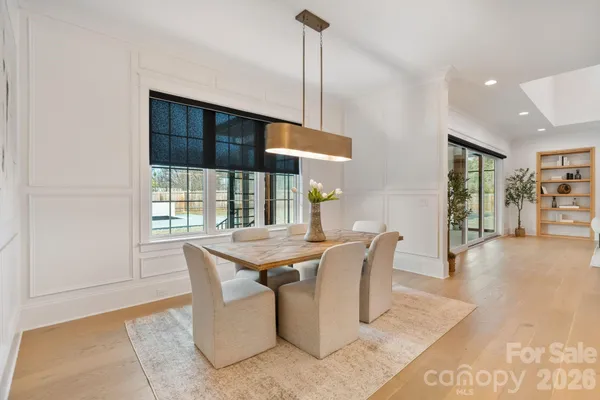 a kitchen with kitchen island stainless steel appliances a dining table and chairs
