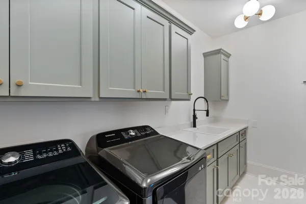 a bathroom with a sink a mirror a vanity and a bathtub