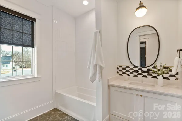 a living room with furniture a rug and a fireplace