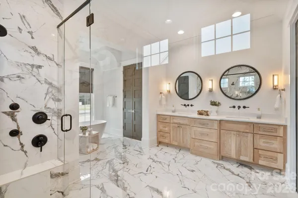 a bathroom with a toilet a sink a mirror and a window