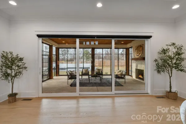 a living room with furniture and a floor to ceiling window