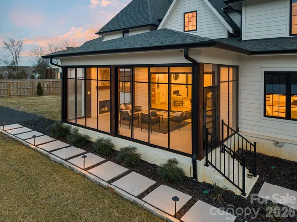 a view of a house with backyard and deck