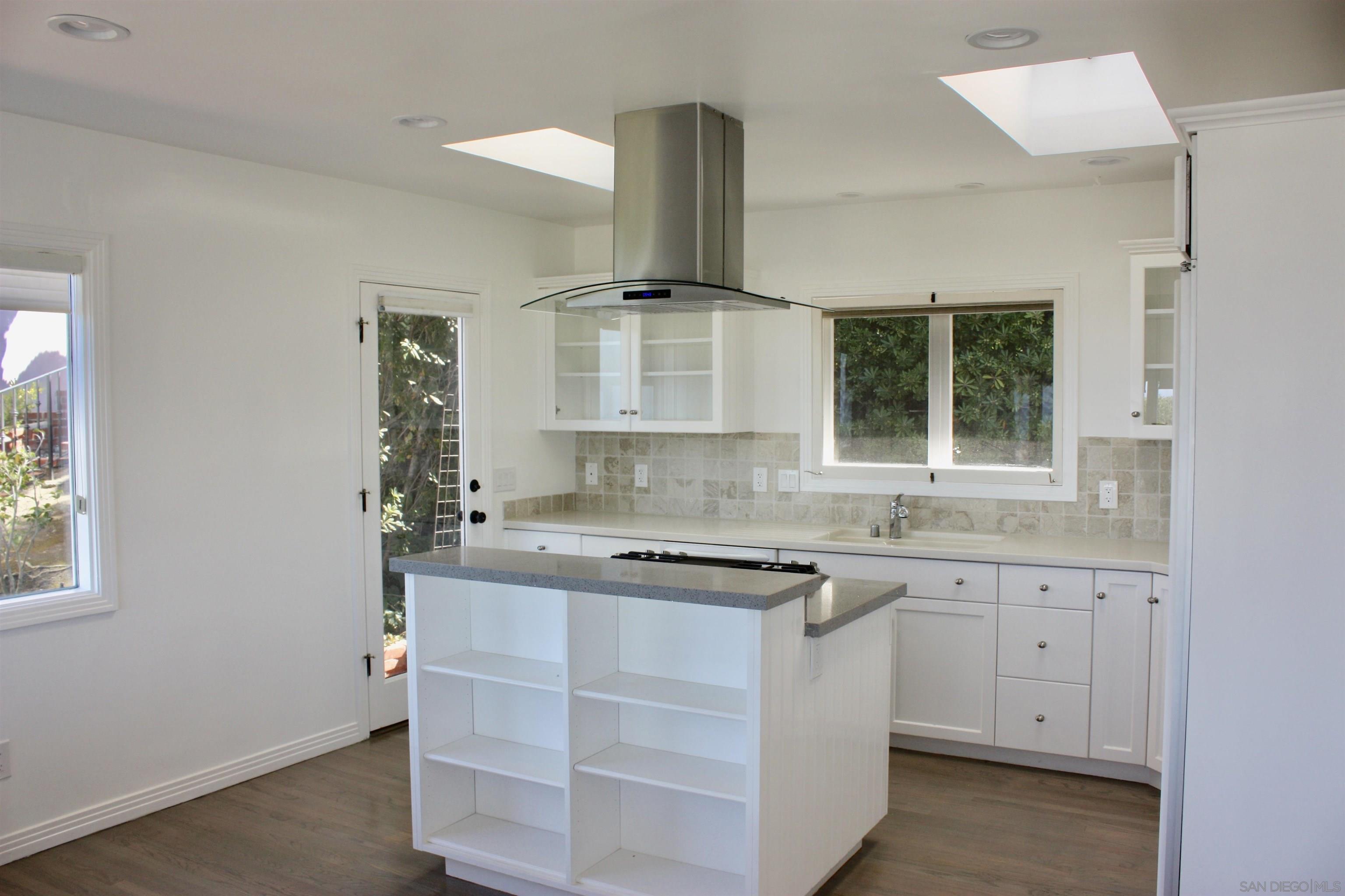 1516 Kearsarge Road La Jolla, CA 92037 - Photo 12 of 22 a kitchen with a sink stove and cabinets