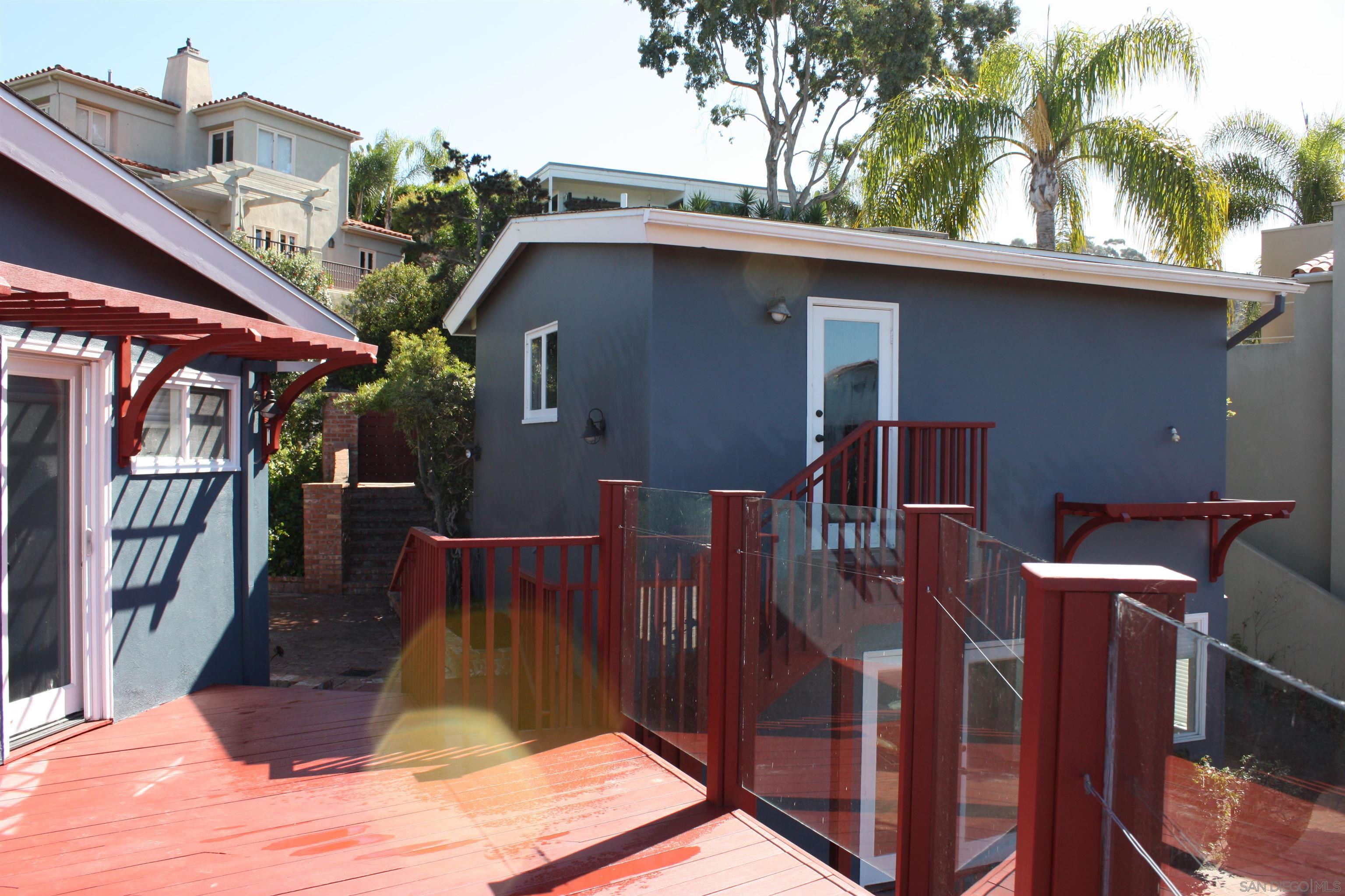 1516 Kearsarge Road La Jolla, CA 92037 - Photo 22 of 22 a view of backyard with outdoor seating and wooden fence