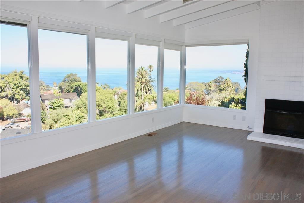 1516 Kearsarge Road La Jolla, CA 92037 - Photo 4 of 22 a view of an empty room with wooden floor and a window
