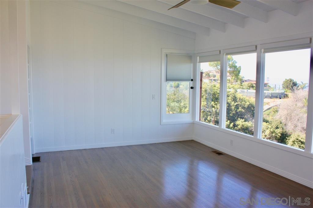 1516 Kearsarge Road La Jolla, CA 92037 - Photo 5 of 22 an empty room with wooden floor and windows