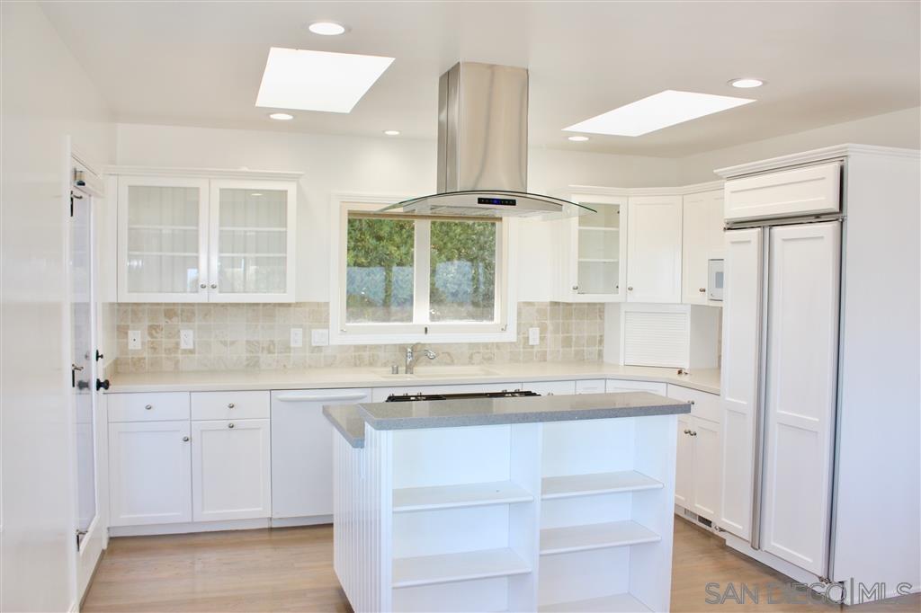 1516 Kearsarge Road La Jolla, CA 92037 - Photo 6 of 22 a kitchen with a sink stove and cabinets