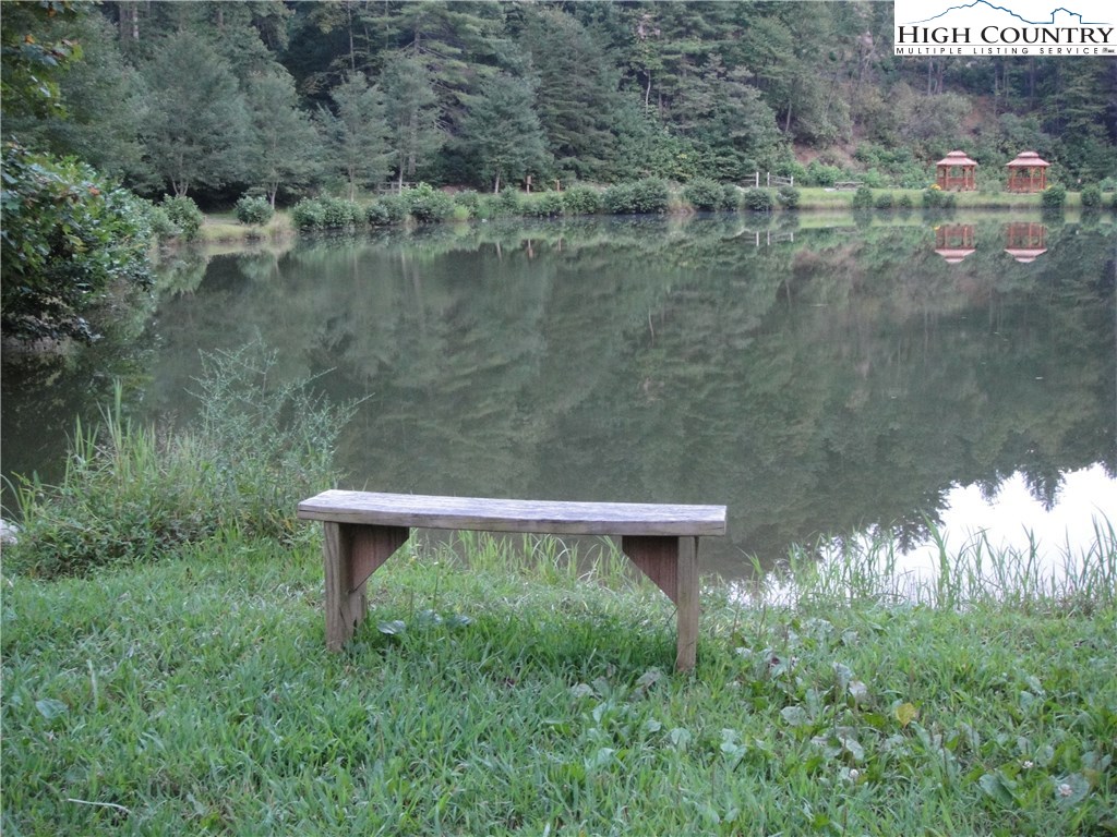 Lot 87 Woodpecker Road Purlear, NC 28665 - Photo 14 of 30 a view of a yard with a bench and lake view