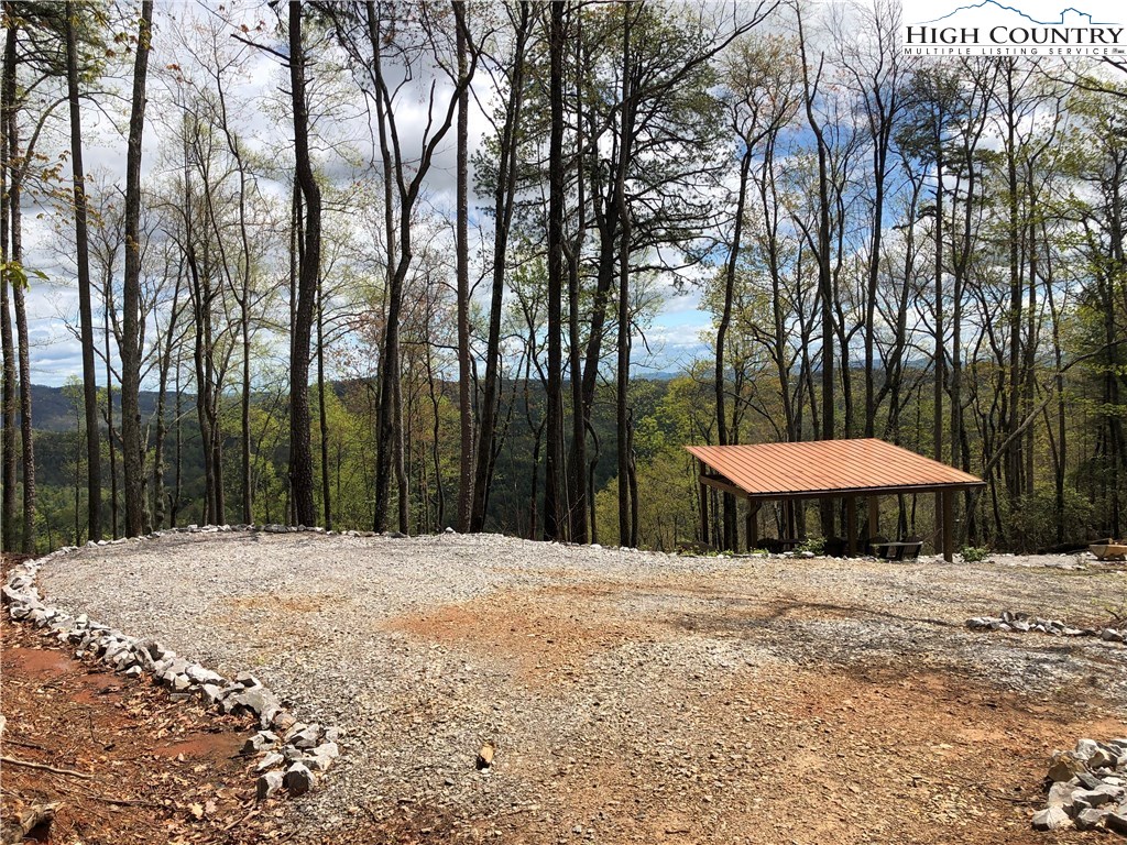 Lot 87 Woodpecker Road Purlear, NC 28665 - Photo 25 of 30 a swimming pool with a table and chairs under an umbrella