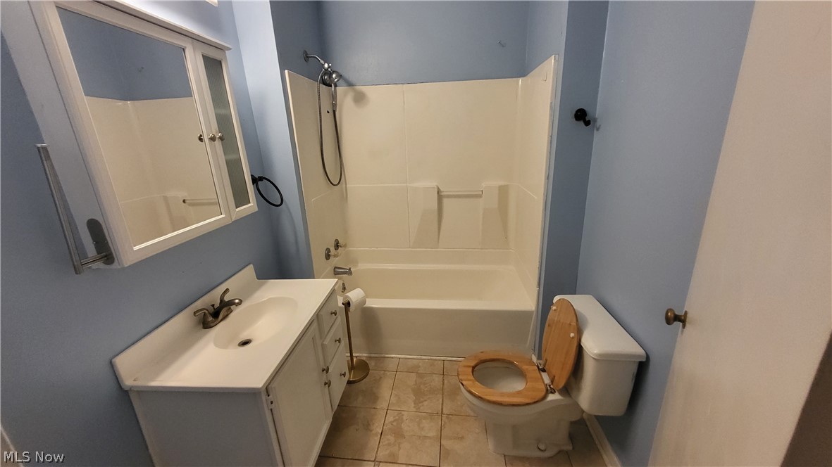 72238 Colerain Road Bridgeport, OH 43912 - Photo 23 of 30 Full bathroom featuring shower / washtub combination, vanity, toilet, and tile floors