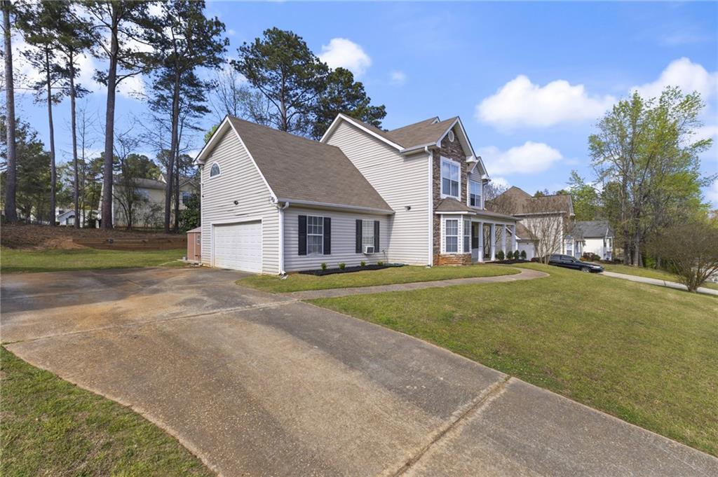 4008 Lindsey Lane Rex, GA 30273 - Photo 2 of 34 a view of a house with a big yard and large trees