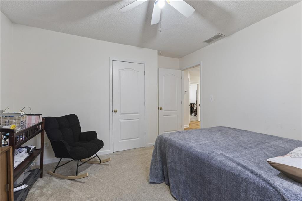4008 Lindsey Lane Rex, GA 30273 - Photo 21 of 34 a bedroom with a bed and chair