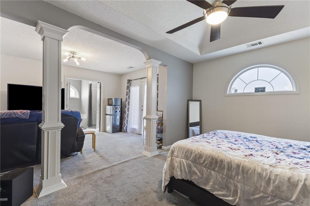 4008 Lindsey Lane Rex, GA 30273 - Photo 22 of 34 a bedroom with a bed and a chandelier