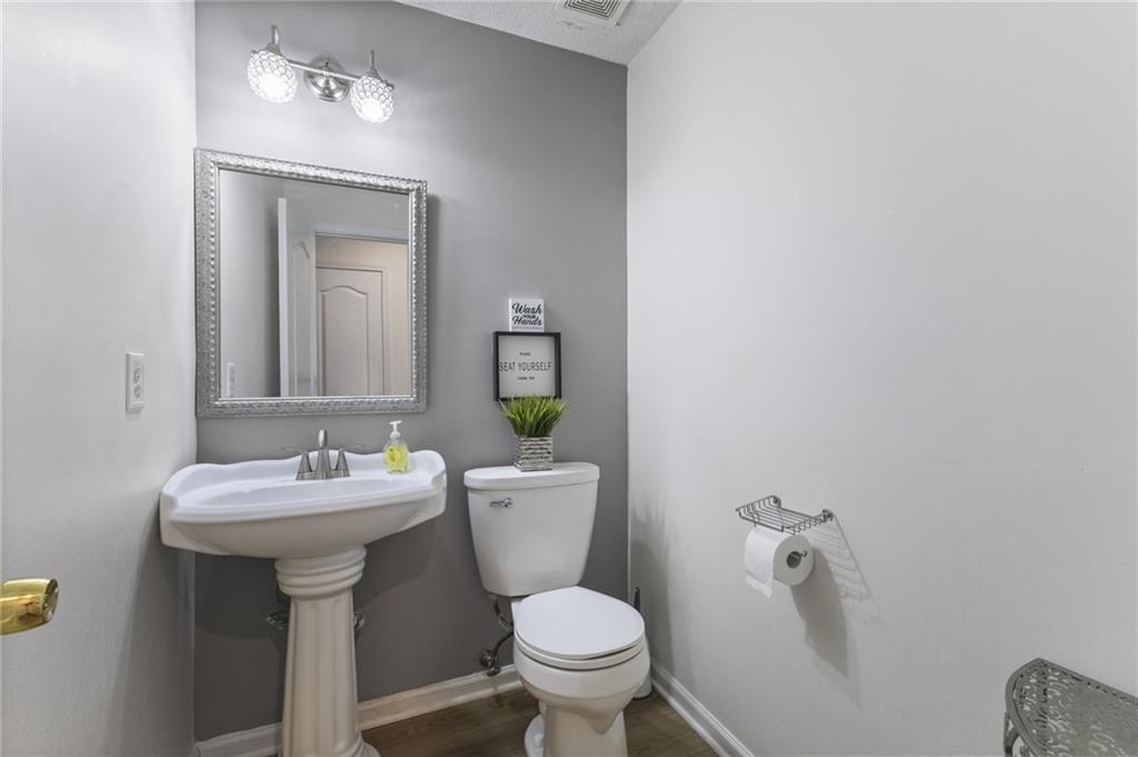 4008 Lindsey Lane Rex, GA 30273 - Photo 26 of 34 a bathroom with a toilet sink and mirror