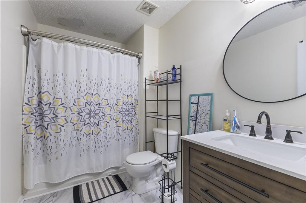 4008 Lindsey Lane Rex, GA 30273 - Photo 29 of 34 a bathroom with a toilet a sink and a mirror