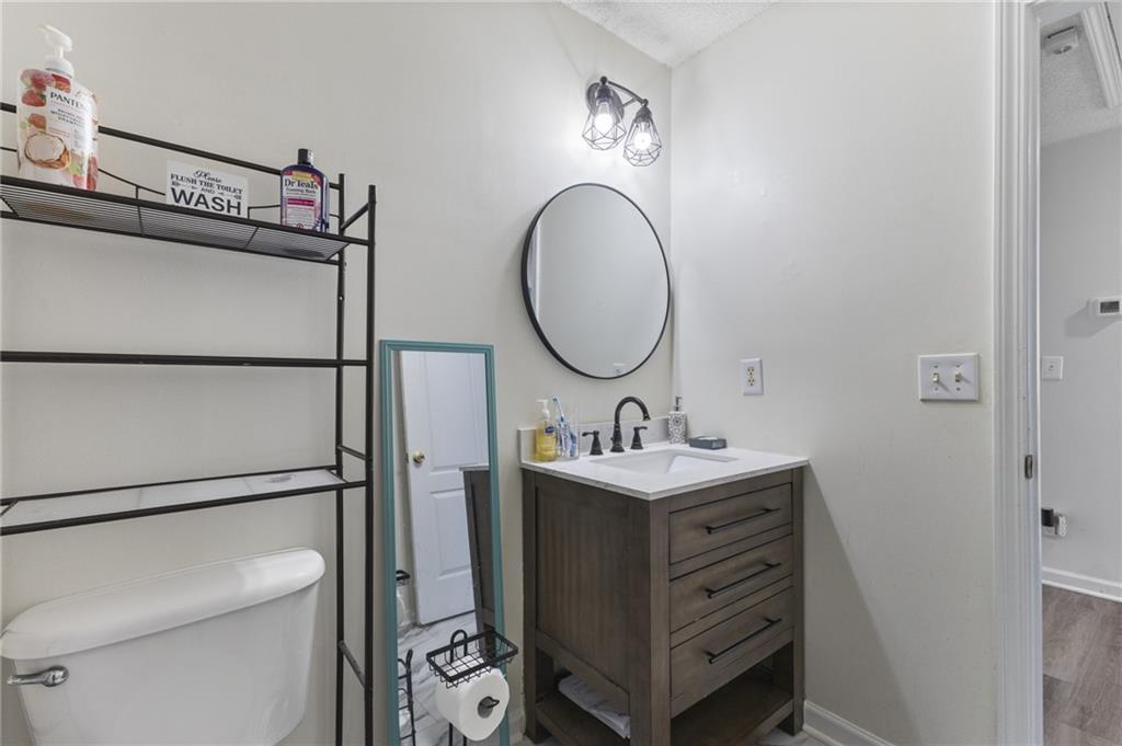 4008 Lindsey Lane Rex, GA 30273 - Photo 30 of 34 a bathroom with a sink and a mirror